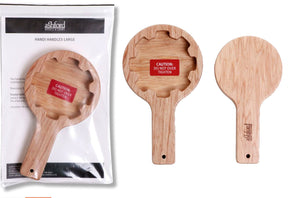 Two Ashford Handi Handles are shown, one in packaging and the other two out of it. The handles have a flat circular top with a slot and a red sticker reading "Caution: Do Not Over Tighten." Branded as "Ashford Handi Handles" by Ashford Handicrafts Limited, these tools are ideal for Ashford looms and can assist those with impaired hand mobility.