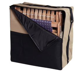 A beige and black carrying case with a partially opened zipper reveals a folded wooden chair, a piece of purple and white patterned fabric, and an Ashford Katie 8-Shaft Table Loom (12") from Ashford Handicrafts Limited inside.