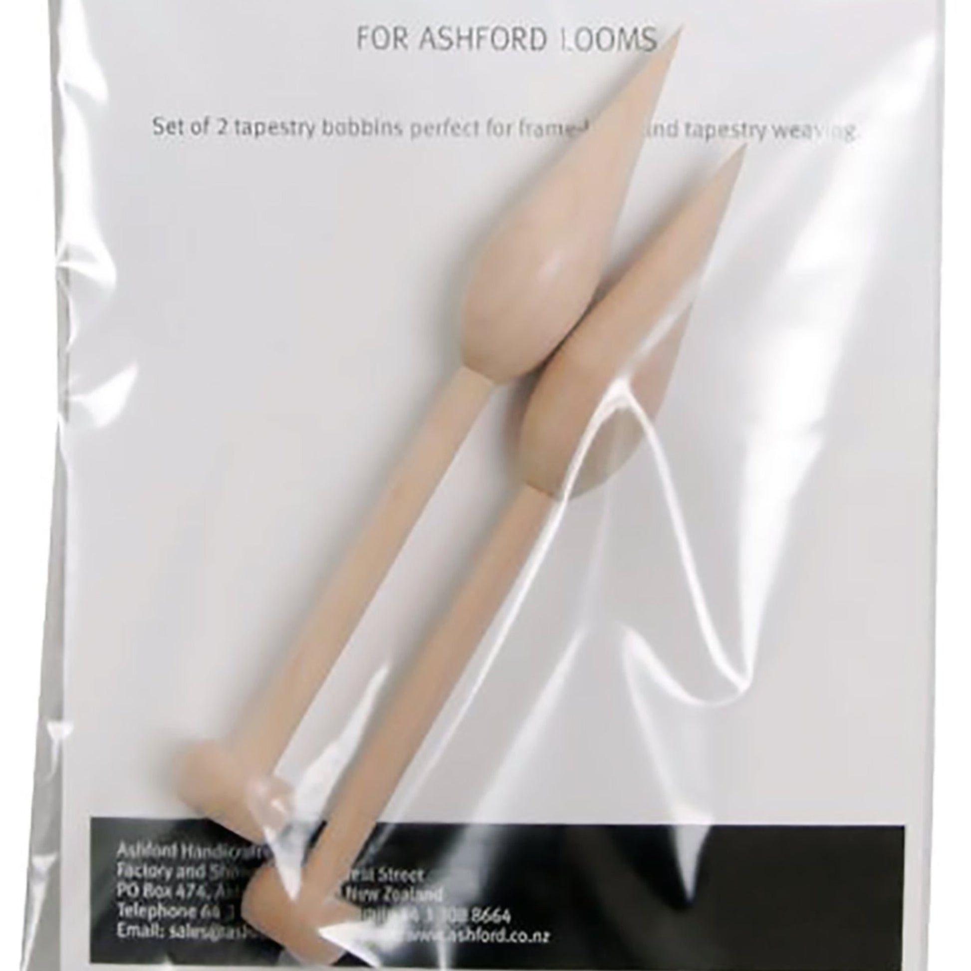 A plastic package containing two Ashford Tapestry Bobbins, Smooth Finish (2/pack), designed for Ashford looms. Perfect for tapestry weaving, the wooden bobbins have pointed ends and are positioned side by side within the clear packaging. The label includes product information and contact details for Ashford Handicrafts Limited.