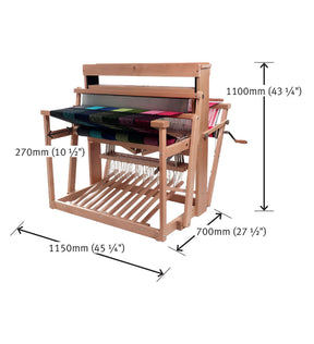 An Ashford Handicrafts Limited weaving loom, model Ashford 38" Jack Floor Loom Eight Shaft, with colorful fabric in progress. This wooden loom measures 1150mm (45 1/4") in width, 700mm (27 1/2") in depth, and 1100mm (43 1/4") in height. It features a foot-operated triple-peg mechanism and includes a slatted shelf beneath the main frame.