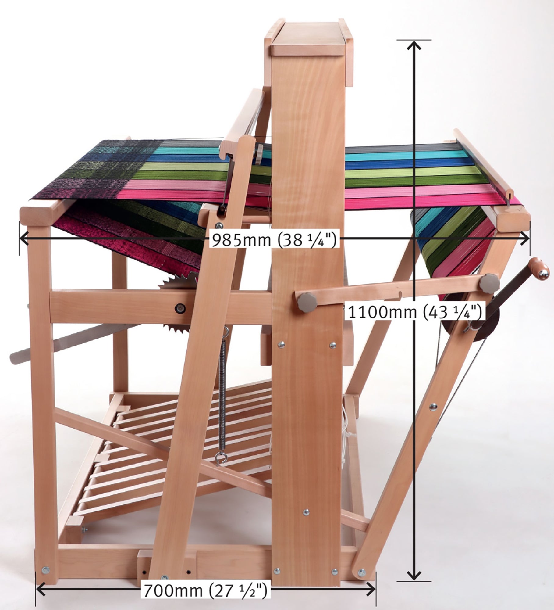 The image shows an Ashford 38" Jack Floor Loom Eight Shaft, 97 cm (38") by Ashford Handicrafts Limited with colorful fabric partially woven on it. There are measurements indicated: width 700mm (27 ½”), depth 985mm (38 ¾”), and height 1100mm (43¼”). The loom has various components and levers visible.