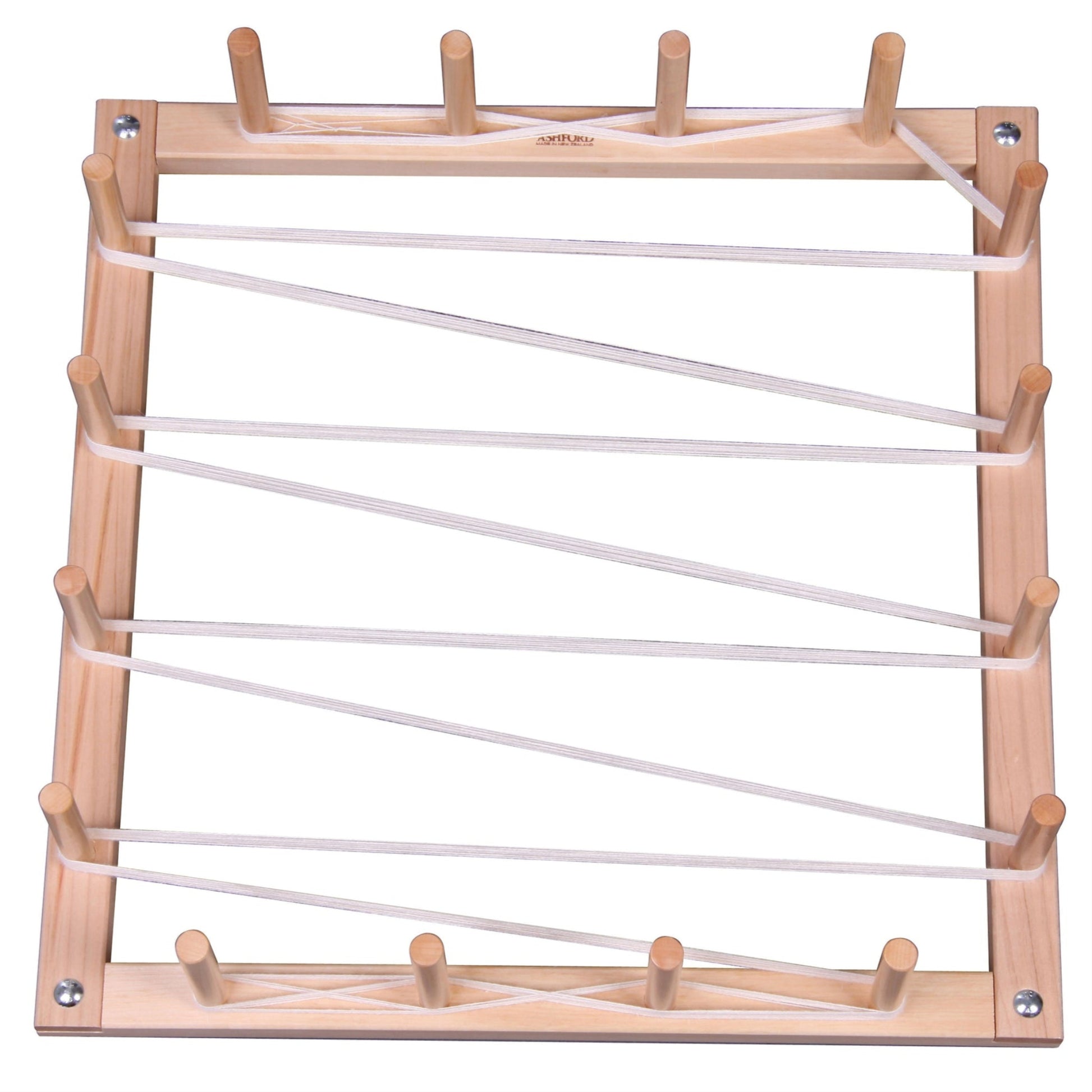 Introducing the Ashford Warping Board by Ashford Handicrafts Limited: a wooden frame featuring multiple vertical dowels on the sides and top, designed to hold diagonal white elastic bands. Perfect for creating various patterns, whether for educational or crafting purposes. The frame boasts light brown edges with tightly stretched bands.