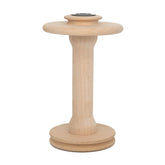 The Ashford Hi-speed Double-Drive Bobbin from Ashford Handicrafts Limited is crafted with a round base and top, made for holding thread or yarn. It has a light beige color and is designed with a smooth finish.