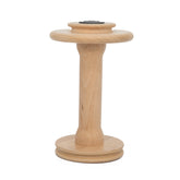 An Ashford Standard Bobbin by Ashford Handicrafts Limited stands upright on a white background, featuring a natural wood finish and a simple cylindrical shaft with two circular ends, typically used for holding thread or yarn.