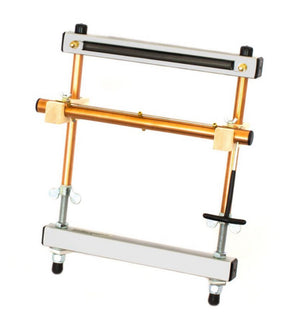 An image showcasing the Mirrix Tapestry Loom from Mirrix Tapestry Looms. This device features two horizontal metallic bars connected by vertical copper tubes, echoing the robust design commonly found in tapestry looms. It includes wing nuts and two wooden cross-braces, and is specifically engineered to hold book spines securely in place during the binding process.