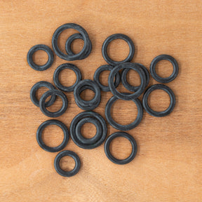 A selection of Bryson Rubber Ring Markers from Bryson Distributing, Inc. is scattered across a wooden surface.