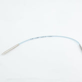 A flexible, light blue guidewire reminiscent of the Addi EasyKnit Turbo Circular Needles by Skacel is lying on a white surface. Much like knitting circular needles, this guidewire is slightly curved and features metal tips on both ends, one of which appears thicker than the other. Printed text can be seen along the wire's length.