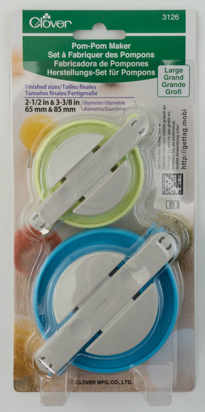 Packaging of a Bryson Distributing, Inc. Pom-Pom Maker set, which includes two circular tools in green and blue. The package indicates sizes of 2-1/2 inches and 3-3/8 inches (65 mm and 85 mm). "Large" is prominently printed on the package with instructions in multiple languages.