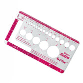 The Accessories Unlimited Knit-Chek is an ideal knitting gauge and ruler for knitters and crocheters. This rectangular tool includes round holes to measure needle sizes, a stitch gauge counter, and a ruler marked in inches and centimeters along the edges, all highlighted in pink and white.