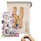 The Loome Tool - Robot Model with Muslin Bag from the brand Loome is a comprehensive crafting kit that includes an all-in-one fiber craft tool, printed instructions, and a fabric bag. The wooden tool features multiple prongs and holes perfect for making pom poms. The beige muslin bag with a drawstring proudly displays the word "LOOME.