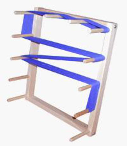 The Beka Warping Board is a wooden wall-mounted rack featuring three horizontal blue fabric straps wrapped around the dowels. This structure, reminiscent of maple warping boards, has multiple wooden rods extending from both sides to form three symmetrical rows for holding and organizing items. It's economical and easy to assemble.