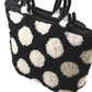 A close-up of the Southern Hills Designs Polka Dot Purse, showcasing its monk's cloth texture with a black background and large white polka dots. The purse is adorned with sturdy, black handles and covered in a soft, wool-like material.