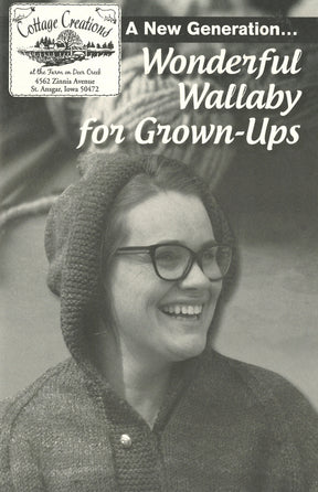 Black-and-white photo of a smiling woman wearing glasses, a hooded sweater with a hand-warming pocket, and looking to her right. The image is overlaid with text: "A New Generation... Wonderful Wallaby For Grown-Ups." Small upper-left logo: Cottage Creations, St. Ansgar, Iowa.