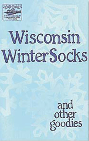 Light blue book cover featuring a snowflake pattern background. The title "Wisconsin Winter Socks and Other Goodies" is written in large, playful blue font. A small logo of the publisher, Cottage Creations, is at the top left corner, hinting at cozy creations like warm thick socks and hat and scarf patterns inside.