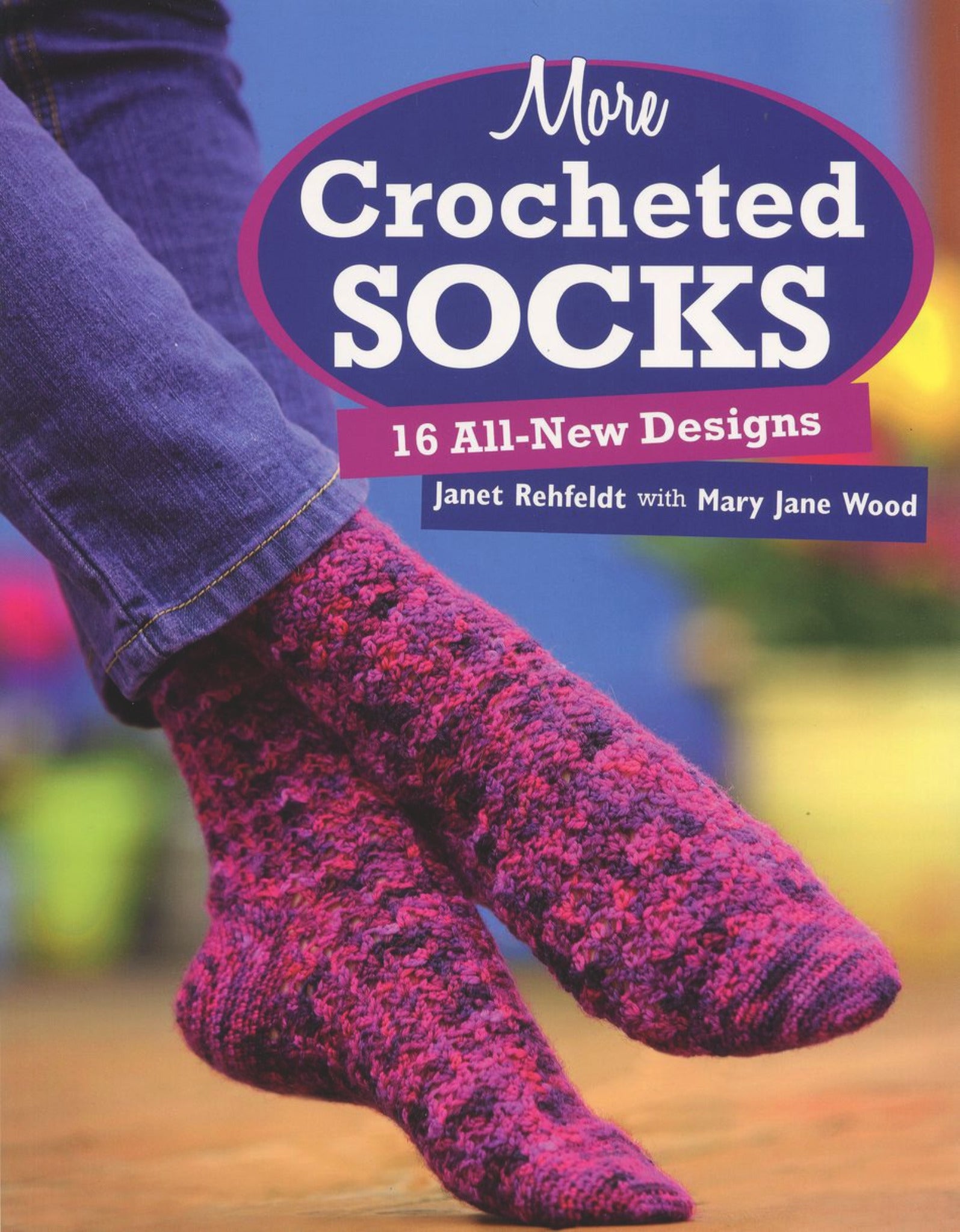 The cover of "More Crocheted Socks" by Martingale & Co showcases a close-up of a person donning cozy, purple and pink crocheted socks set against a beautifully blurred blue and yellow backdrop.