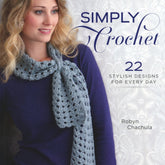 The book cover titled "Simply Crochet" by Robyn Chachula, from Ingram Content, features a woman wearing a light blue crocheted scarf over a navy blue top against a decorative light grey background. It showcases 22 stylish designs for every day, including patterns for baby sweaters and stylish shrugs.