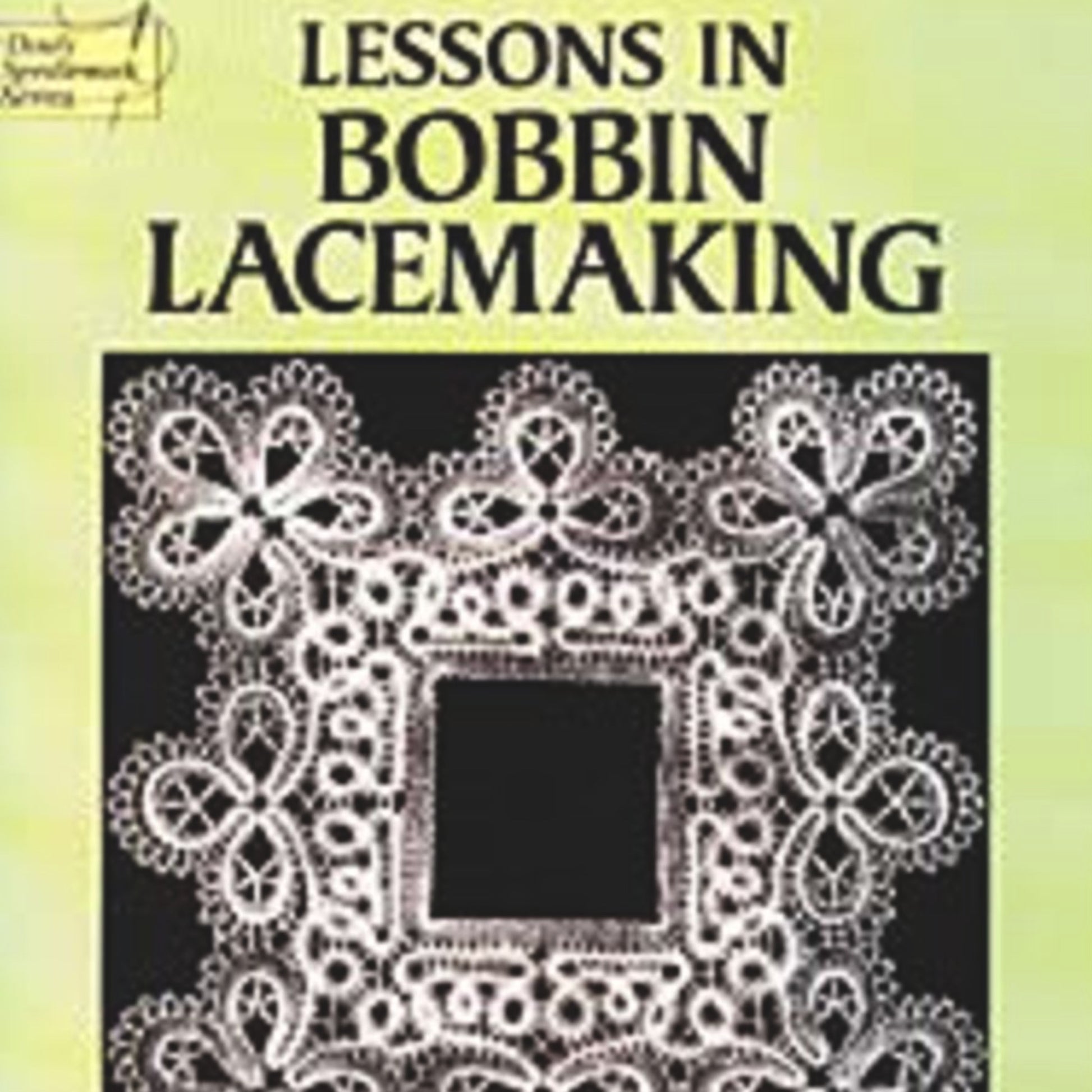 A book cover from Dover Books features an intricate lace design surrounding a square inset on a pale green background. The title, "Lessons in Bobbin Lacemaking," is displayed in bold black letters at the top, showcasing detailed patterns typical of Bobbin Lace Designs.