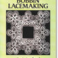 The cover of "Lessons in Bobbin Lacemaking" by Doris Southard, published by Dover Books, highlights intricate bobbin lace arranged in a square pattern adorned with loops and floral shapes on a black background, all set against a light green backdrop. The title appears at the top while the author’s name is showcased at the bottom.