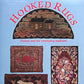 The book cover for "Hooked Rugs: History and the Continuing Tradition" by Schiffer Publishing Co. showcases vibrant color photos of various hooked rug designs, including scenes featuring a house, geometric patterns, floral arrangements, and animals at the bottom. The title is in a striking red font set against a light blue background, making it an ideal resource for any aspiring textile artist.