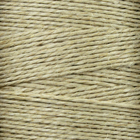 Close-up image of Stuart C. Hurlbert & Co.'s Soft Finish Linen Warps. The beige-colored, natural fibers display a rough texture with intertwined strands running horizontally across the image, reminiscent of tapestry weaving.