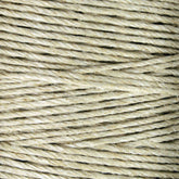 Close-up image of Soft Finish Linen Warps by Stuart C. Hurlbert & Co., showcasing beige twine wound in tight, parallel loops with a coarse, fibrous texture reminiscent of traditional tapestry weaving.