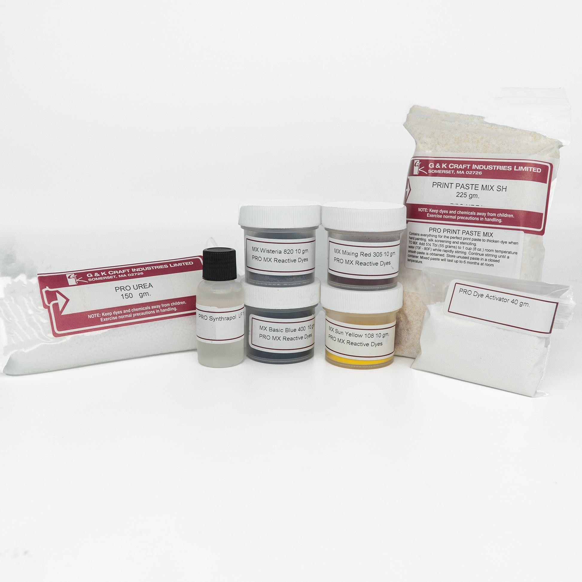 A collection of various dyeing and printing materials, including jars, packets, and bottles, all labeled with red and white stickers from G & K Craft. The Warp Painting Kit includes Pro Urea, Print Paste Mix, different Procion Fiber Reactive Dyes for warp painting on cellulose fibers, and a Pro Dye Activator perfect for weaving projects.