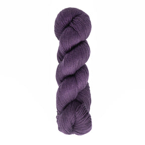 A skein of Cascade Heritage Sock Yarn by Cascade Yarns, in a deep purple hue, tightly twisted and crafted from superwash merino wool, is set against a plain white background, highlighting its impeccable stitch definition.