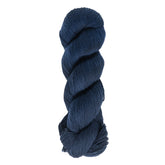 A twisted skein of Cascade Heritage Sock Yarn in dark navy blue, crafted from soft superwash merino wool, is set against a white background. This fingering weight yarn from Cascade Yarns features a slightly textured appearance, promising excellent stitch definition for your next project.