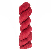 A skein of deep red Cascade Heritage Sock Yarn by Cascade Yarns, elegantly twisted against a plain white background, showcases exquisite stitch definition.