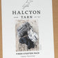 The image showcases the packaging for Halcyon Yarn's Fiber Starter - spinning sample pack, featuring a black-and-white photo of three bundles of yarn in various colors and textures. Ideal for Spin-Off fans, the packaging includes the phrases "Happy Spinning!" and "Maine Yarn Est. 1971.