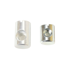 Two Schacht Replacement Barrel Nuts (from a 5-pack) by Schacht Spindle Co. are shown against a white background. The metallic cylindrical nuts have slotted tops and threaded holes. The nut on the left is larger in both height and diameter compared to the smaller nut on the right.