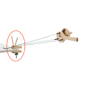 The Schacht Incredible Rope Machine Separator Kit by Schacht Spindle Co. features a wooden mechanical apparatus with gears and strings, highlighted by a red circle around a specific part of the device. The strings are connected to a central arm and are held in place by wooden pegs, indicating a point of interest or instruction.