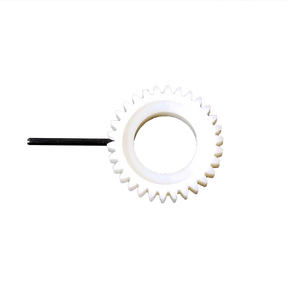 A white Table Loom & Rigid Heddle Ratchet Gear & Pin by Schacht Spindle Co. features sharp teeth attached to a black rod extending from one side. The replacement ratchet gear is positioned against a plain black background, emphasizing the gear's shape and details.