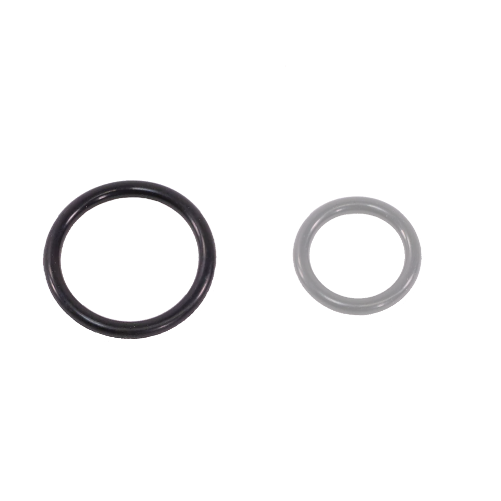 Two black O-rings of different sizes are placed side by side on a white background, much like the components in Schacht Spindle Co.'s Variable Dent Reed Heddle Retainer Ring (4/pkg). The O-ring on the left is larger, while the one on the right, resembling a replacement retainer ring, is smaller.