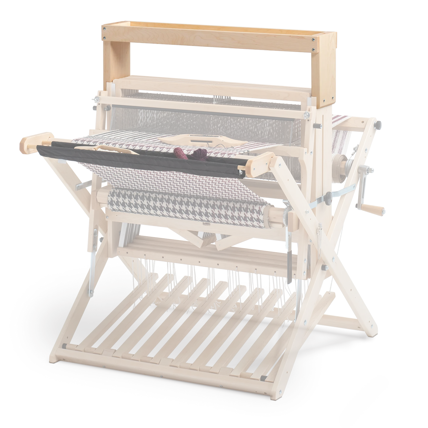 The Schacht High Castle Tray by Schacht Spindle Co. is a wooden handloom weaving machine made from light-colored wood, equipped with various levers and rollers. It prominently displays intricately woven fabric and features detailed mechanical components essential for weaving textiles, including a built-in tray for the convenient storage of tools.