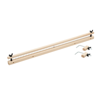 A Schacht Raddle for Standard Floor Looms by Schacht Spindle Co. is a long, narrow piece of wood with evenly spaced holes along its length, accompanied by two metal components with pins and handles, likely used for precise measurements or woodworking alignments.