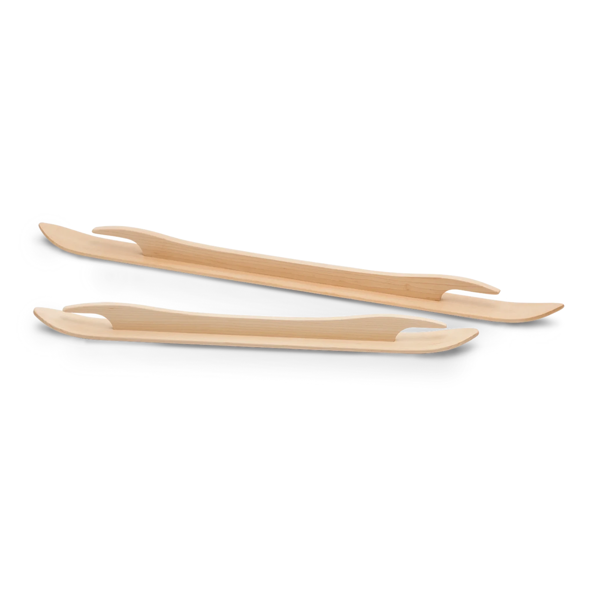 Two Schacht Ski Shuttle utensils, designed with a sleek and stylish appearance, are positioned parallel to each other on a white background. These 18" shuttles by Schacht Spindle Co. feature flat, slightly curved shapes with tapered ends, reminiscent of tools used in weaving looms and combining the functionalities of a fork and a spoon.