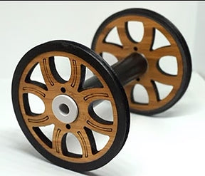 The Majacraft Co. Majacraft Wood (Bamboo) Standard Bobbin features intricately designed wheels on each end with a symmetrical pattern of cutouts, black handles and inner rims, while the main part of the wheels retains the natural bamboo color.