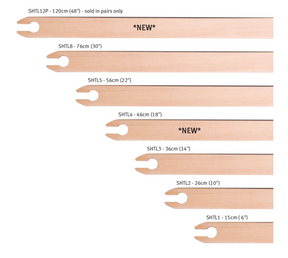 An image featuring seven Ashford Stick Shuttles by Ashford Handicrafts Limited, crafted from Silver Beech hardwood and meticulously sanded to a smooth finish perfect for tapestry work. The shuttles, shown in descending order from the top, have lengths of 120 cm (NEW), 76 cm, 56 cm, 46 cm, 36 cm (NEW), 26 cm, and 15 cm.