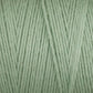 Close-up of Cotton Carpet Warp 8/4, featuring light green cotton yarn with tightly wound fibers. The texture is soft and smooth, revealing individual strands that highlight its thickness and vibrant, colorfast hue—perfect for crafting colorful rag rugs.