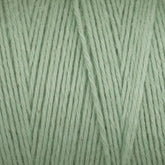 Close-up of Cotton Carpet Warp 8/4, featuring light green cotton yarn with tightly wound fibers. The texture is soft and smooth, revealing individual strands that highlight its thickness and vibrant, colorfast hue—perfect for crafting colorful rag rugs.