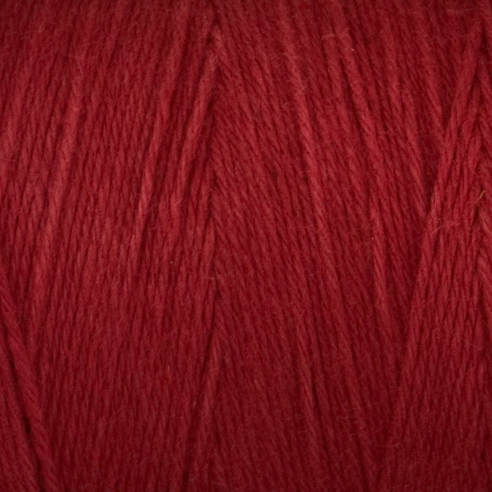 The Cotton Carpet Warp 8/4 yarn showcases a soft, plush texture with vibrant, colorfast red fibers. Ideal for knitting or crocheting projects like cozy garments and colorful rag rugs, it ensures long-lasting creations with tightly spun durability.