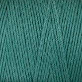 A close-up of Cotton Carpet Warp 8/4 in teal reveals tightly woven, smooth cotton strands with fibrous details and uniform texture, ideal for vibrant rag rugs.