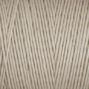 Close-up of a skein of Cotton Carpet Warp 8/4 yarn, ideal for crafting rag rugs. The tightly wound strands showcase the beige texture and thickness, forming neat parallel lines for a uniform, durable surface.