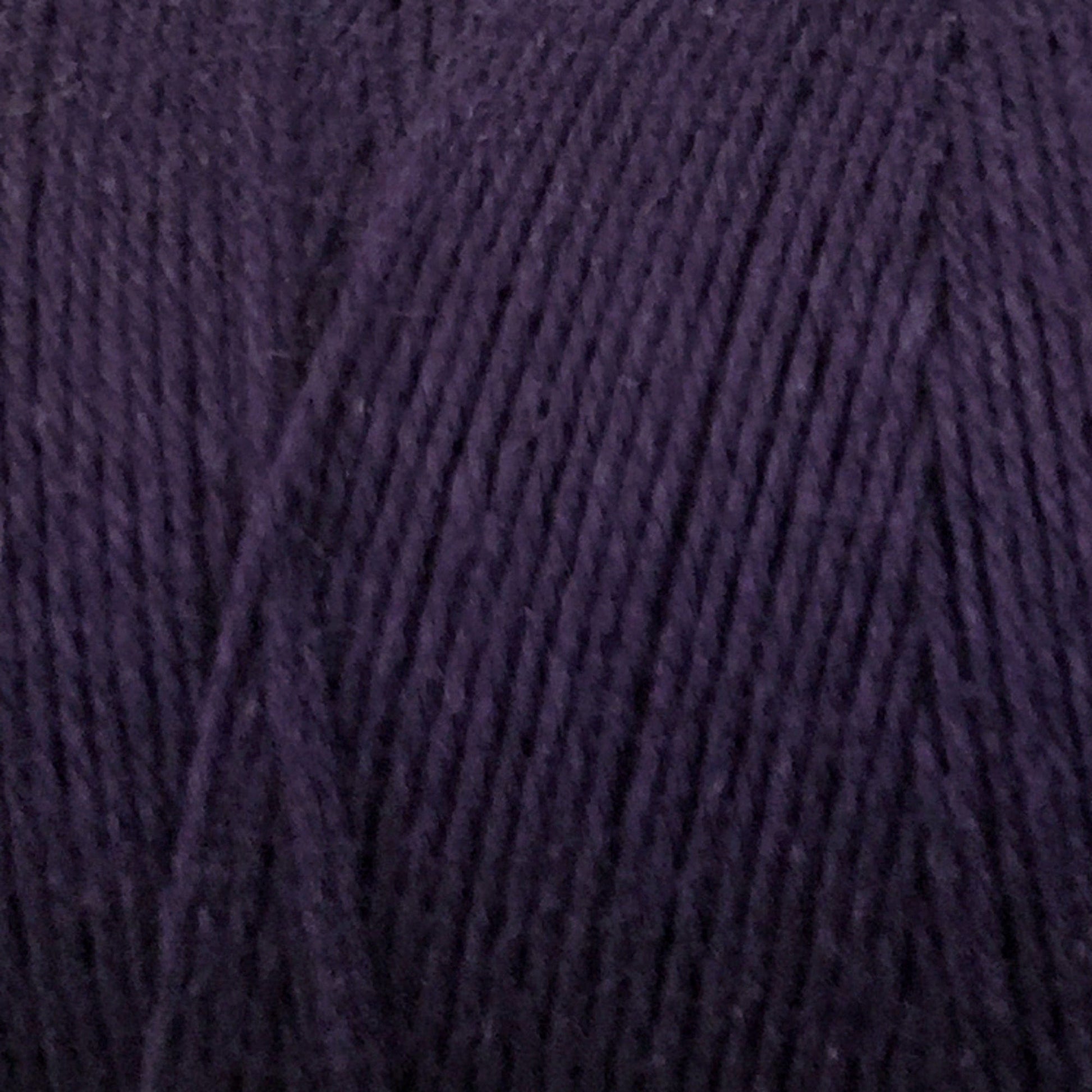 Close-up of dark purple Cotton Carpet Warp 8/4, featuring fine, tightly wound fibers. The soft and smooth texture highlights the intricate details of the colorfast material.