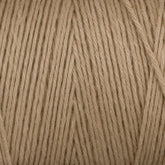 Close-up of a ball of Cotton Carpet Warp 8/4 yarn, showcasing tightly wound fibers and smooth texture. Evenly distributed strands form diagonal patterns, enhancing the durability and visual appeal of your rag rugs.