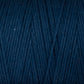 A close-up of the Cotton Carpet Warp 8/4 reveals tightly wound dark blue strands with a soft, textured surface. The fibers form a diagonal pattern, highlighting the weave and rich color—ideal for sturdy rag rugs.