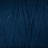 A close-up of the Cotton Carpet Warp 8/4 reveals tightly wound dark blue strands with a soft, textured surface. The fibers form a diagonal pattern, highlighting the weave and rich color—ideal for sturdy rag rugs.