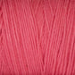 Close-up of a skein of Cotton Carpet Warp 8/4, showing tightly spun pink fibers running parallel like those in rag rugs. The texture is soft with gentle lines and slight color variations, highlighting its natural weave, ensuring vibrancy and colorfastness.