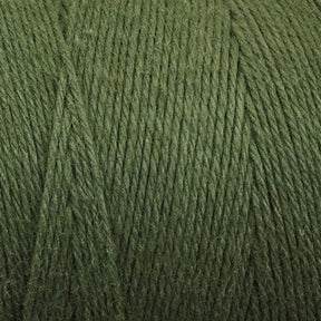 Close-up of Cotton Carpet Warp 8/4, a green thread perfect for rag rugs. Tightly wound and colorfast, its textured surface offers subtle shading variations for depth. The fibrous detail is emphasized.